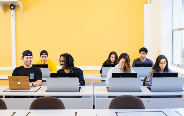 Students with computers in classroom
